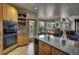 Modern eat-in kitchen featuring wooden cabinets, stainless appliances, and granite counters at 5910 Mccart Ranch Cir, Elizabeth, CO 80107