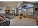 Comfortable living room boasts large windows with views and a plush leather sofa at 5910 Mccart Ranch Cir, Elizabeth, CO 80107
