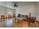 Bright living room with hardwood floors, a ceiling fan, and natural light streaming in through large windows at 5910 Mccart Ranch Cir, Elizabeth, CO 80107