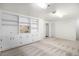 A finished basement area features built-in shelving and storage, plus two closets and neutral patterned carpet at 6762 E Briarwood Dr, Centennial, CO 80112