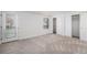 Bright bedroom featuring sliding closet doors and a door to the exterior at 6762 E Briarwood Dr, Centennial, CO 80112