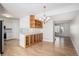 Open concept dining and living room with modern light fixture and bar area at 6762 E Briarwood Dr, Centennial, CO 80112