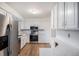Well-lit kitchen features stainless steel appliances, white cabinets, and sleek countertops at 6762 E Briarwood Dr, Centennial, CO 80112