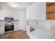 Well-lit kitchen with white cabinets, marble countertops, and stainless steel appliances at 6762 E Briarwood Dr, Centennial, CO 80112