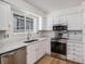 Updated kitchen with stainless steel appliances, marble countertops and white cabinets at 6762 E Briarwood Dr, Centennial, CO 80112