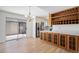 Dining area with a bar, wooden cabinets, and sliding glass doors to the patio at 6762 E Briarwood Dr, Centennial, CO 80112