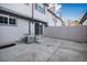 A view of the back of the home, with a concrete patio, fence, and air conditioning unit at 6762 E Briarwood Dr, Centennial, CO 80112