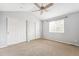 Bedroom with carpet flooring, ceiling fan, window, and double closets at 1663 W 135Th Way, Denver, CO 80234