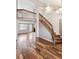 Bright living room boasts beautiful hardwood floors, a staircase, and an open floor plan at 1663 W 135Th Way, Denver, CO 80234