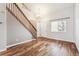 Bright living room boasts beautiful hardwood floors, staircase, and a large window at 1663 W 135Th Way, Denver, CO 80234