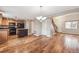 Open concept living room featuring hardwood floors, natural light, and a view into the kitchen area at 1663 W 135Th Way, Denver, CO 80234