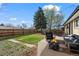 Expansive backyard with a patio, fire pit, and mature trees, offering a relaxing outdoor space at 7496 Clay St, Westminster, CO 80030