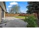 Backyard features a concrete patio, privacy fence, mature tree, and grass at 7496 Clay St, Westminster, CO 80030