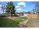 Large backyard with a privacy fence, lush lawn, mature tree, and concrete patio at 7496 Clay St, Westminster, CO 80030