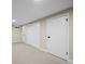 Neutral-toned basement space showcasing multiple doors and a minimalist design at 7496 Clay St, Westminster, CO 80030