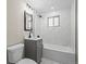 Modern bathroom with gray vanity, marble-style tiles, and sleek fixtures for a luxurious feel at 7496 Clay St, Westminster, CO 80030