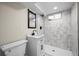 Modern basement bathroom with marble-like shower and contemporary fixtures, and a black framed mirror at 7496 Clay St, Westminster, CO 80030