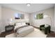 Staged bedroom with large windows, stylish furniture, and plush carpet for a cozy retreat at 7496 Clay St, Westminster, CO 80030