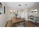 Staged dining room with table, chairs, bench, and modern decor, illuminated by natural light at 7496 Clay St, Westminster, CO 80030