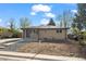 Charming brick home with a well-manicured front yard and inviting blue front door at 7496 Clay St, Westminster, CO 80030