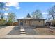 Charming brick home with a well-manicured front yard and inviting blue front door at 7496 Clay St, Westminster, CO 80030