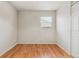 Bright bedroom featuring hardwood flooring and a window with view of the exterior at 7412 W 76Th Ave, Arvada, CO 80003