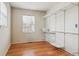Bedroom featuring hardwood flooring, window, and a large closet with shelving at 7412 W 76Th Ave, Arvada, CO 80003