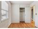 Bright bedroom featuring hardwood flooring and a window view of the exterior at 7412 W 76Th Ave, Arvada, CO 80003