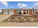 Well-maintained single-story brick home featuring an attached two-car garage and manicured landscaping at 7412 W 76Th Ave, Arvada, CO 80003