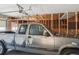 View of garage interior, shows open framing and a silver Dakota pick-up truck at 7412 W 76Th Ave, Arvada, CO 80003