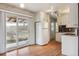 Kitchen with sliding glass door and white appliances at 7412 W 76Th Ave, Arvada, CO 80003