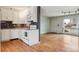 Bright kitchen with white cabinets, stainless steel appliances, and hardwood floors at 7412 W 76Th Ave, Arvada, CO 80003