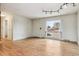 Bright living room with wood floors, large window, and stylish ceiling lighting at 7412 W 76Th Ave, Arvada, CO 80003