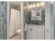 Stylish bathroom features a tiled wall, glass-door shower, and a white vanity with storage at 9172 W 88Th Cir, Westminster, CO 80021
