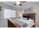 Cozy bedroom with a wood-trimmed bed, window with blinds, and a decorative wall art at 9172 W 88Th Cir, Westminster, CO 80021