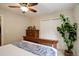 A spacious bedroom features a large window, double closet, wood trim and a ceiling fan at 9172 W 88Th Cir, Westminster, CO 80021