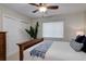 Bedroom with a white closet doors, window with blinds, and a cozy bed with blue accents at 9172 W 88Th Cir, Westminster, CO 80021
