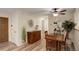 Dining area flows to entry and kitchen, hardwood floors, and a stylish buffet table at 9172 W 88Th Cir, Westminster, CO 80021