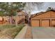 Warm exterior view showcasing garages, siding, and landscaped walkway, enhancing curb appeal at 9172 W 88Th Cir, Westminster, CO 80021