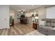 Open-concept living and dining area with modern decor and hardwood flooring at 9172 W 88Th Cir, Westminster, CO 80021