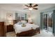 Bright bedroom with queen-size bed, ceiling fan, and sliding glass door at 9172 W 88Th Cir, Westminster, CO 80021