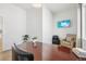 Bright home office with wood desk, comfortable chair, and mounted TV at 2284 Apple St, Frederick, CO 80504