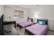 Comfortable bedroom with two twin beds, a work desk, and a bright window with blinds at 1415 S Chambers #106 Rd, Aurora, CO 80017