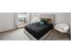 Serene bedroom featuring a comfortable bed with accent pillows, a side table and a bright window at 1415 S Chambers #106 Rd, Aurora, CO 80017