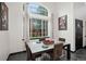 Bright dining room with a large window, a modern table, and stylish decor at 1415 S Chambers #106 Rd, Aurora, CO 80017