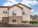 Charming exterior of a multi-level home with stone accents and a well-maintained yard at 1415 S Chambers #106 Rd, Aurora, CO 80017