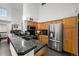 Spacious kitchen with granite countertops, stainless steel appliances, and wood cabinets at 1415 S Chambers #106 Rd, Aurora, CO 80017