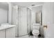 Compact bathroom with a glass-enclosed shower, white vanity, toilet, and neutral decor at 1885 S Quebec Way # G104, Denver, CO 80231