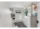 Bright bathroom featuring a bathtub, shower with glass doors, and decorative black and white floor rug at 1885 S Quebec Way # G104, Denver, CO 80231