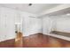 Bedroom with laminate wood flooring, white trim, sliding door closet and an entrance to another room at 1885 S Quebec Way # G104, Denver, CO 80231